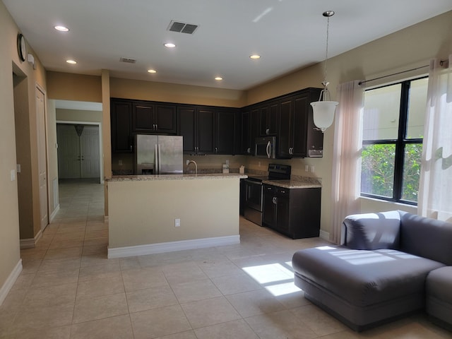 4295 55th St, Vero Beach, FL 32967 - kitchen with stainless steel appliances, light stone countertops, baseboards, dark cabinetry, and recessed lighting