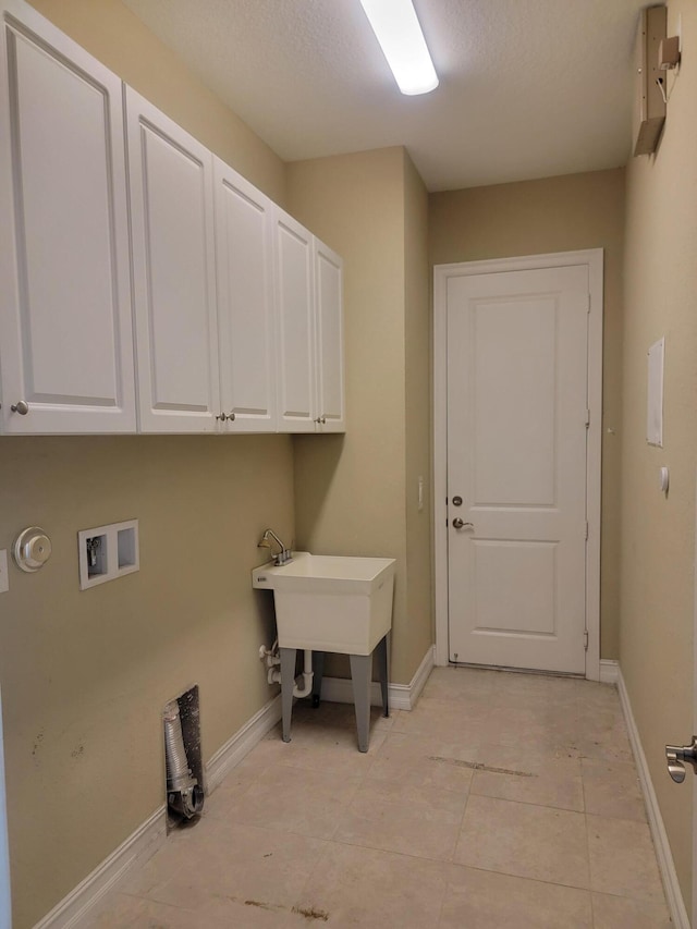 4295 55th St, Vero Beach, FL 32967 - laundry room featuring hookup for a washing machine, baseboards, cabinet space, and light tile patterned floors
