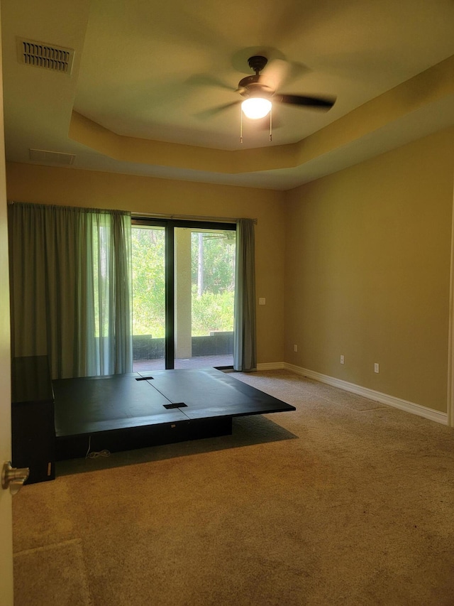 4295 55th St, Vero Beach, FL 32967 - carpeted spare room with ceiling fan, a raised ceiling, and baseboards