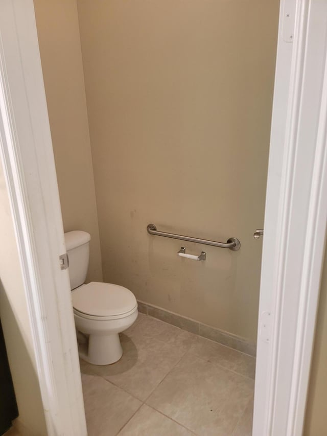 4295 55th St, Vero Beach, FL 32967 - bathroom with tile patterned floors, toilet, and baseboards