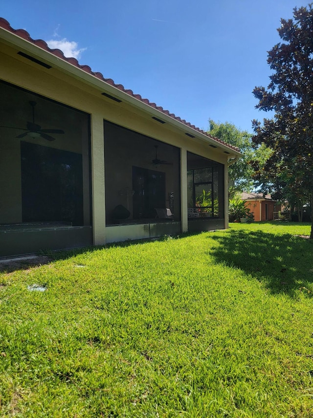 4295 55th St, Vero Beach, FL 32967 - view of grassy yard with a sunroom and a ceiling fan