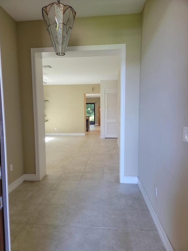 4295 55th St, Vero Beach, FL 32967 - corridor with baseboards and light tile patterned floors