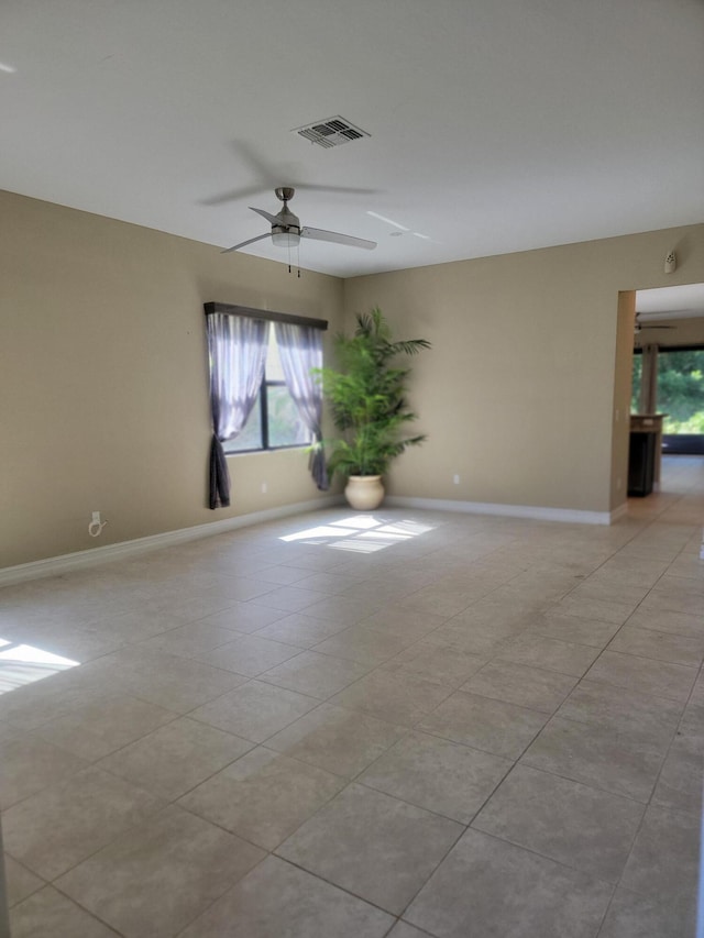 4295 55th St, Vero Beach, FL 32967 - spare room featuring healthy amount of natural light, baseboards, ceiling fan, and light tile patterned flooring