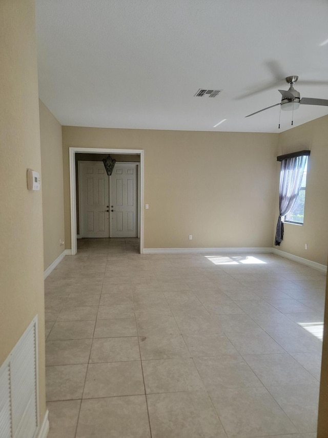 4295 55th St, Vero Beach, FL 32967 - empty room with a ceiling fan, light tile patterned floors, and baseboards