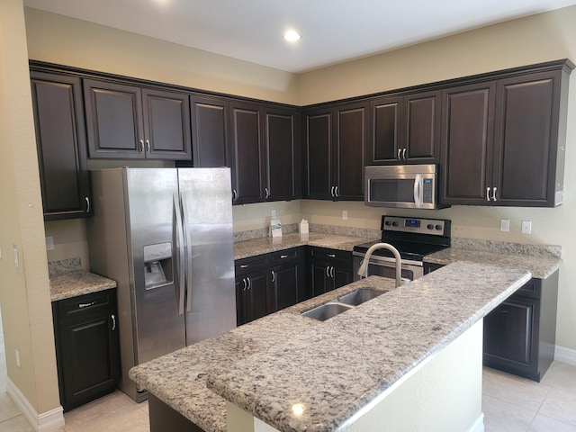 4295 55th St, Vero Beach, FL 32967 - kitchen featuring appliances with stainless steel finishes, a sink, light tile patterned floors, baseboards, and recessed lighting