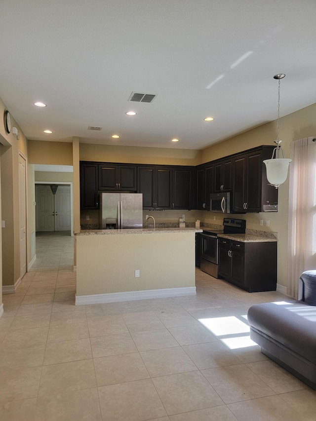 4295 55th St, Vero Beach, FL 32967 - kitchen featuring stainless steel appliances, baseboards, recessed lighting, light tile patterned floors, and hanging light fixtures