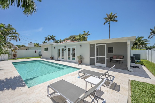 2585 SE 6th St, Pompano Beach, FL 33062 - view of swimming pool featuring french doors, a patio, a fenced backyard, and central AC unit
