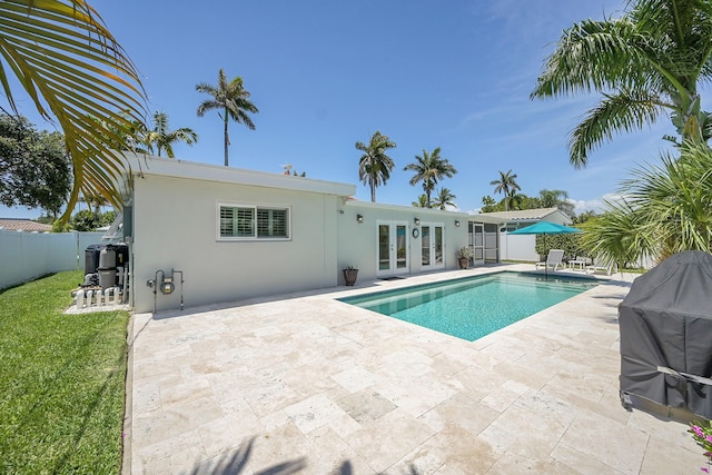 2585 SE 6th St, Pompano Beach, FL 33062 - view of swimming pool featuring french doors, a fenced backyard, and a patio