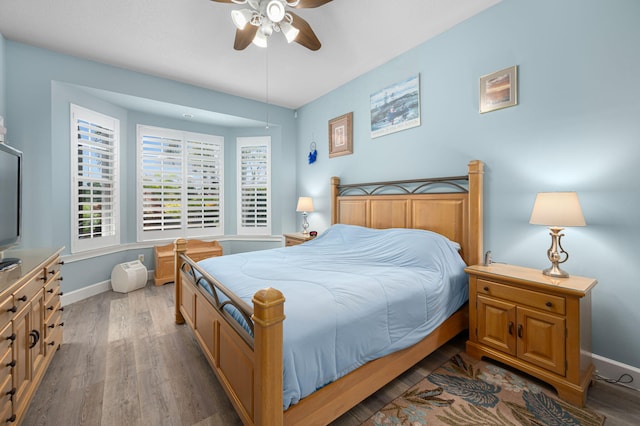 550 SW Sanctuary Dr, Port Saint Lucie, FL 34986 - bedroom with wood finished floors, baseboards, and ceiling fan