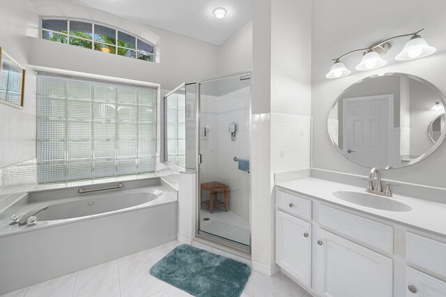 550 SW Sanctuary Dr, Port Saint Lucie, FL 34986 - full bath featuring a bath, vanity, a shower stall, and tile patterned floors