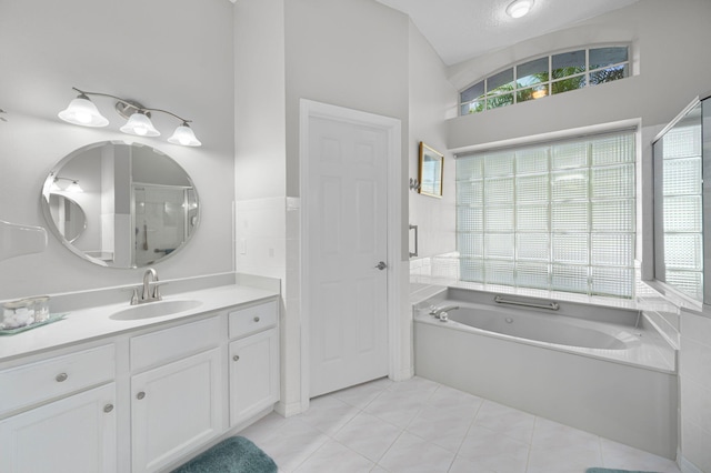 550 SW Sanctuary Dr, Port Saint Lucie, FL 34986 - full bathroom featuring a garden tub, vanity, and tile patterned flooring