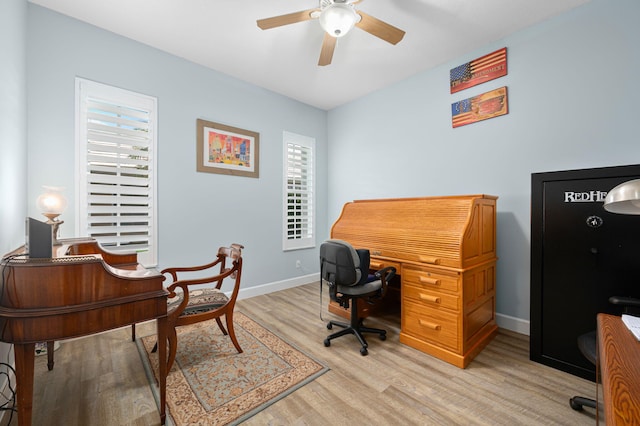 550 SW Sanctuary Dr, Port Saint Lucie, FL 34986 - office area with light wood finished floors, ceiling fan, and baseboards