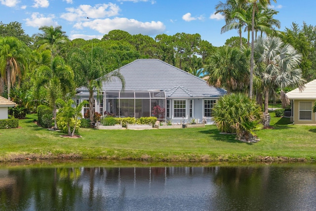 550 SW Sanctuary Dr, Port Saint Lucie, FL 34986 - rear view of property featuring a yard, a water view, a lanai, and a tile roof