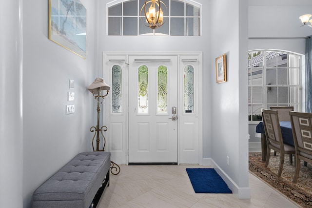 550 SW Sanctuary Dr, Port Saint Lucie, FL 34986 - entryway with a chandelier, plenty of natural light, and baseboards