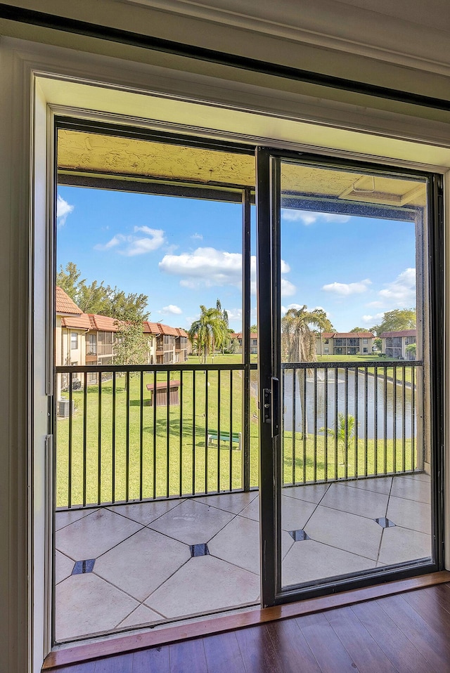 21895 Lake Forest Cir Unit 201, Boca Raton, FL 33433 - doorway to outside with a water view, wood-type flooring, and a residential view