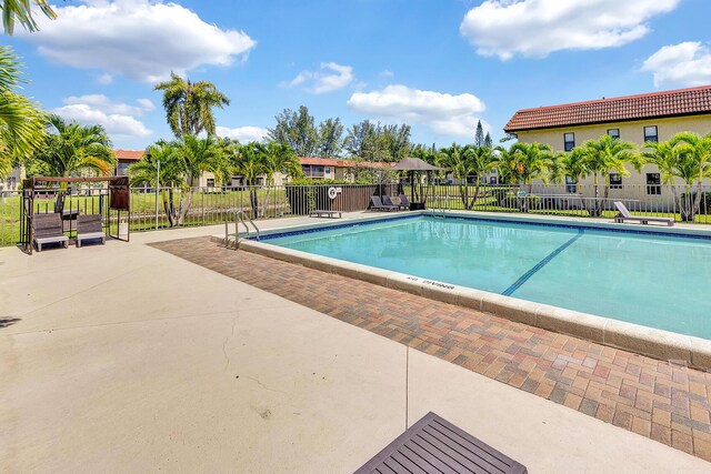 21895 Lake Forest Cir Unit 201, Boca Raton, FL 33433 - community pool featuring a patio