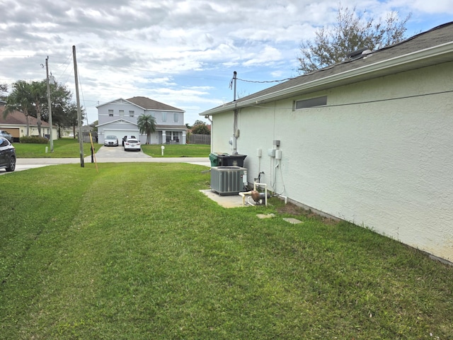 4365 SW Appleseed Rd, Port Saint Lucie, FL 34953 - view of grassy yard featuring central air condition unit