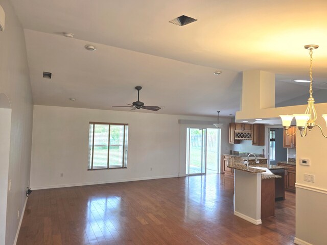 4365 SW Appleseed Rd, Port Saint Lucie, FL 34953 - kitchen featuring vaulted ceiling, baseboards, brown cabinetry, dark wood-style floors, and a ceiling fan