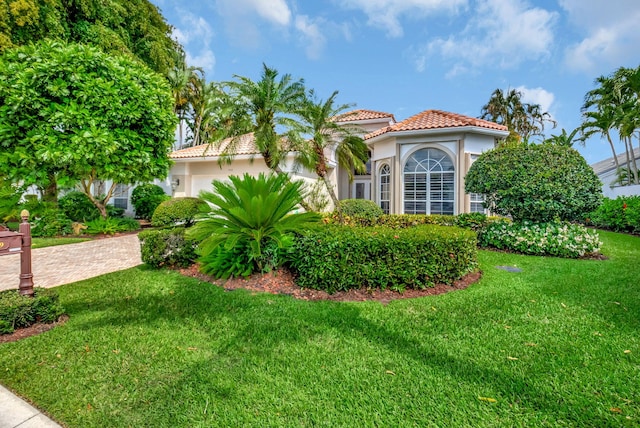 7919 L Aquila Way, Delray Beach, FL 33446 - mediterranean / spanish home featuring stucco siding, a tile roof, an attached garage, and a front lawn