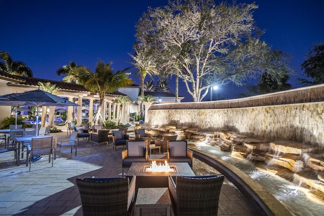 7919 L Aquila Way, Delray Beach, FL 33446 - patio at night featuring an outdoor fire pit and a patio