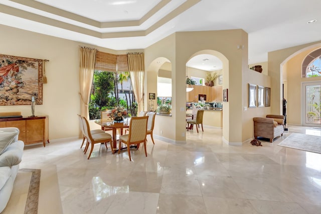 7919 L Aquila Way, Delray Beach, FL 33446 - dining room with arched walkways, baseboards, and a raised ceiling