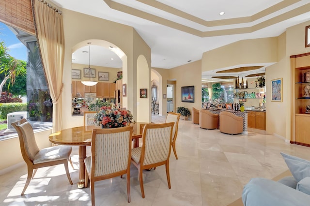 7919 L Aquila Way, Delray Beach, FL 33446 - dining space featuring plenty of natural light, arched walkways, and a tray ceiling