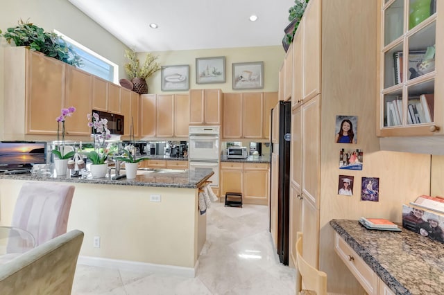 7919 L Aquila Way, Delray Beach, FL 33446 - kitchen featuring black appliances, light brown cabinetry, dark stone counters, and glass insert cabinets