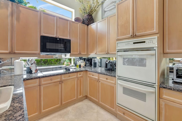 7919 L Aquila Way, Delray Beach, FL 33446 - kitchen featuring black appliances, dark stone counters, light brown cabinets, and light tile patterned floors