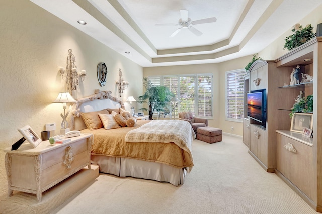 7919 L Aquila Way, Delray Beach, FL 33446 - bedroom featuring light colored carpet, a raised ceiling, a ceiling fan, and baseboards