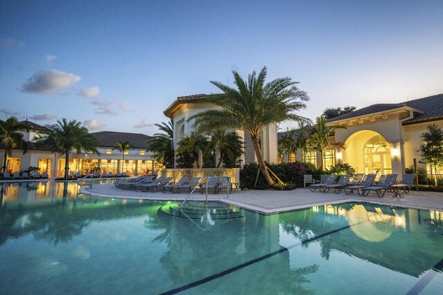 7919 L Aquila Way, Delray Beach, FL 33446 - pool at dusk with a patio and a community pool