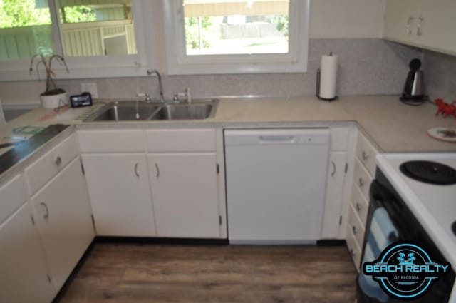 4318 7th Ave, Marianna, FL 32446 - kitchen with white dishwasher, a sink, white cabinets, wood finished floors, and light countertops