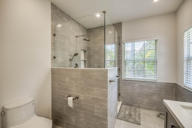 15048 85th Rd N, The Acreage, FL 33470 - full bath with toilet, tile walls, walk in shower, vanity, and tile patterned floors