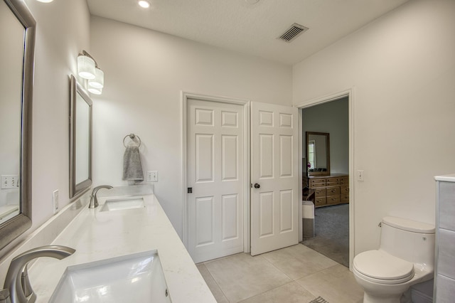 15048 85th Rd N, The Acreage, FL 33470 - bathroom with tile patterned flooring, toilet, double vanity, and recessed lighting