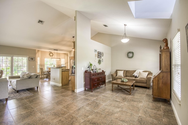 15048 85th Rd N, The Acreage, FL 33470 - living area featuring plenty of natural light, baseboards, vaulted ceiling, and stone finish flooring