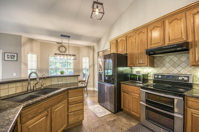 15048 85th Rd N, The Acreage, FL 33470 - kitchen with appliances with stainless steel finishes, a sink, tasteful backsplash, under cabinet range hood, and brown cabinets