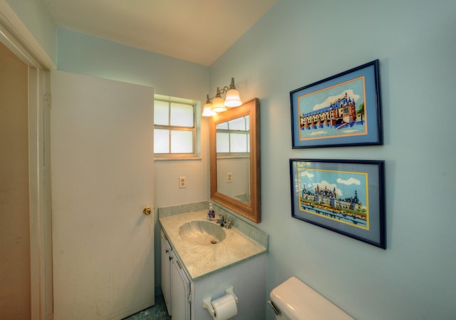 bathroom featuring toilet and vanity
