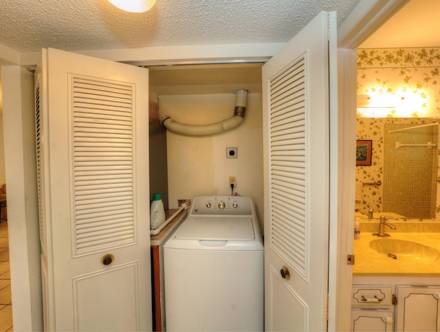 laundry room featuring washer / clothes dryer and a textured ceiling