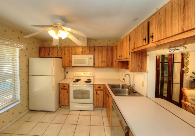 kitchen with white appliances, a sink, wallpapered walls, light countertops, and brown cabinetry