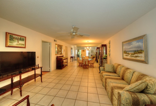 living room with a chandelier, a ceiling fan, and light tile patterned floors