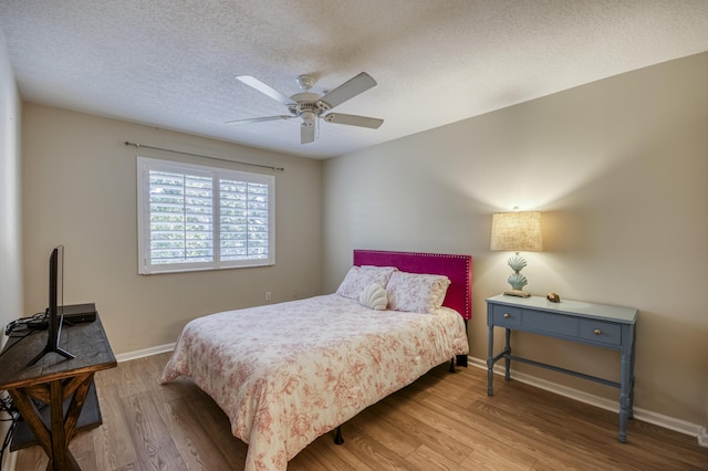236 Village Blvd Unit 1303, Tequesta, FL 33469 - bedroom featuring wood finished floors, baseboards, a textured ceiling, and a ceiling fan