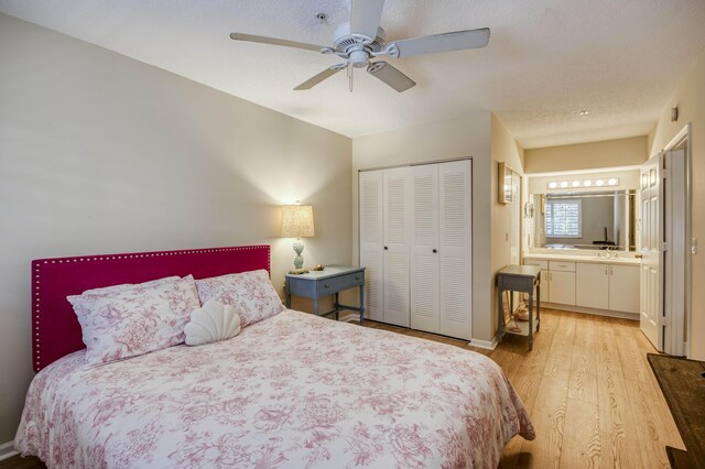 236 Village Blvd Unit 1303, Tequesta, FL 33469 - bedroom with light wood-type flooring, a closet, ceiling fan, and ensuite bathroom
