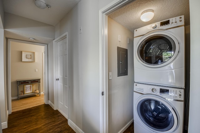 236 Village Blvd Unit 1303, Tequesta, FL 33469 - laundry area with stacked washer / drying machine, electric panel, dark wood finished floors, baseboards, and a textured ceiling