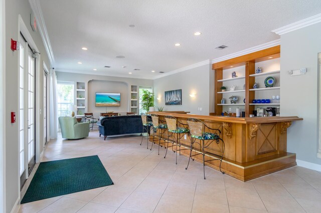 236 Village Blvd Unit 1303, Tequesta, FL 33469 - indoor dry bar featuring built in shelves, ornamental molding, recessed lighting, tile patterned flooring, and baseboards