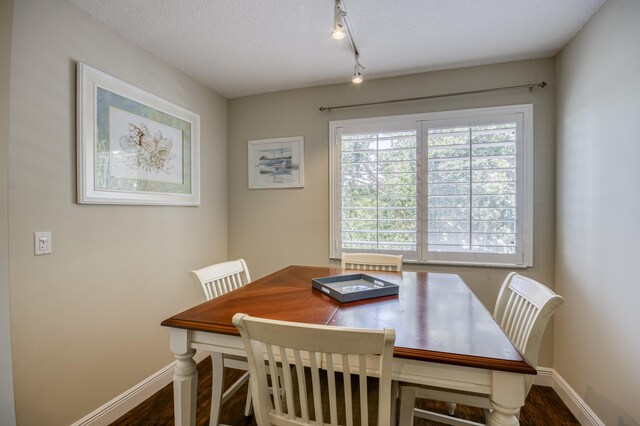 236 Village Blvd Unit 1303, Tequesta, FL 33469 - dining room featuring baseboards, dark wood-type flooring, and a textured ceiling