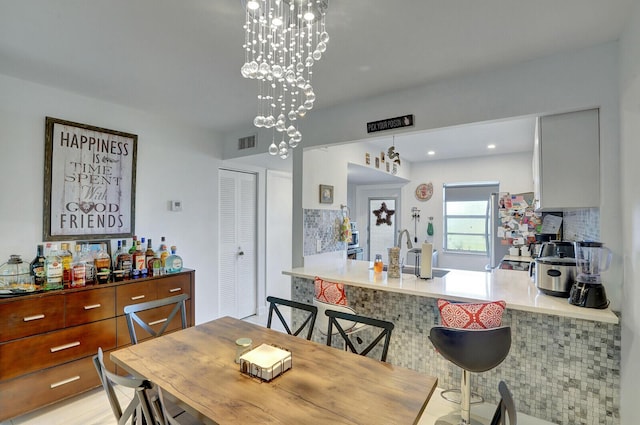 130 Lake Meryl Dr Unit 226, West Palm Beach, FL 33411 - dining space featuring a chandelier