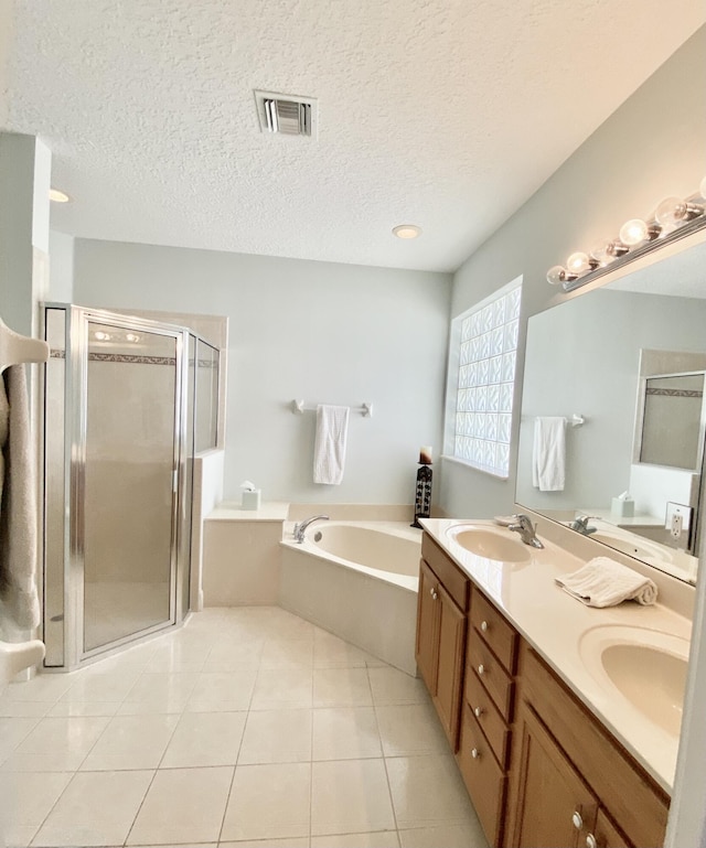 225 Clocktower Dr, Jupiter, FL 33458 - bathroom with a bath, a stall shower, tile patterned flooring, a textured ceiling, and double vanity