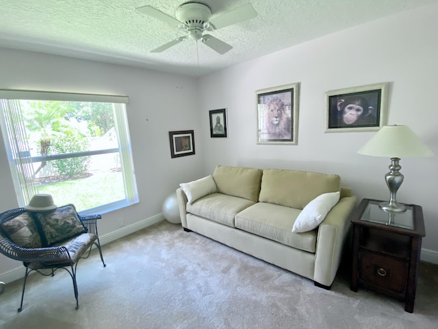 225 Clocktower Dr, Jupiter, FL 33458 - carpeted living room featuring baseboards, a ceiling fan, and a textured ceiling