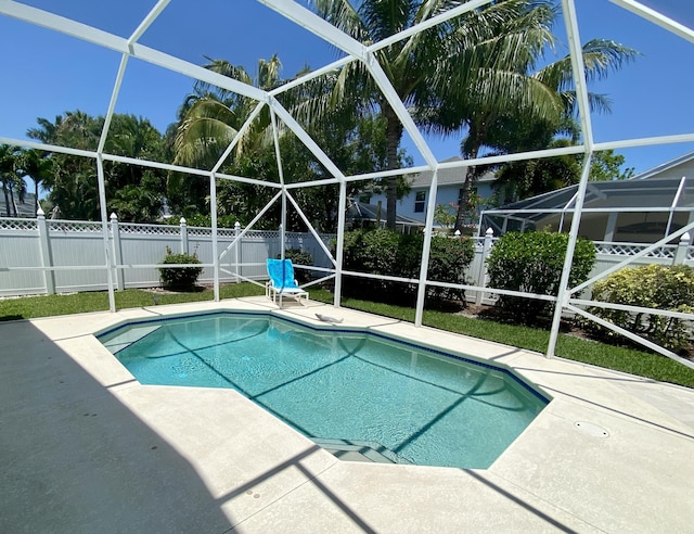 225 Clocktower Dr, Jupiter, FL 33458 - view of swimming pool with a fenced backyard, a patio, and glass enclosure