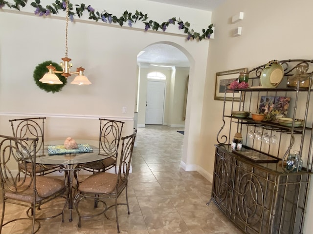 225 Clocktower Dr, Jupiter, FL 33458 - dining space featuring arched walkways, baseboards, and tile patterned flooring