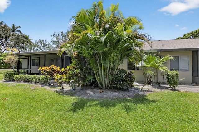 8583 Overset Ln Unit C, Boca Raton, FL 33496 - view of side of property featuring a lawn, a sunroom, and stucco siding